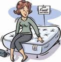 Woman testing out a bed